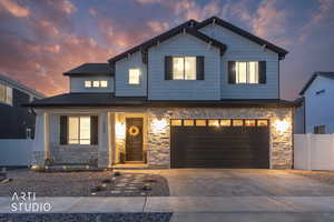 Craftsman inspired home with stone siding, covered porch, concrete driveway, and an attached garage