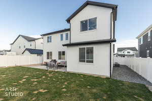 Back of property with a patio, a fenced backyard, stucco siding, and an outdoor living space