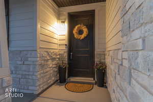 View of exterior entry featuring stone siding