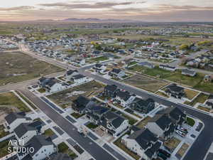 Aerial view of property and surrounding area with nearby suburban area