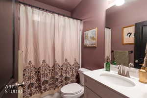 Full bathroom featuring vanity and curtained shower