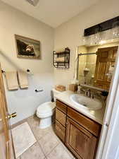 Bathroom with vanity, light tile patterned flooring, and a shower stall