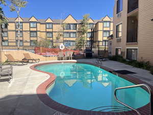 Community pool featuring a patio area and grilling area