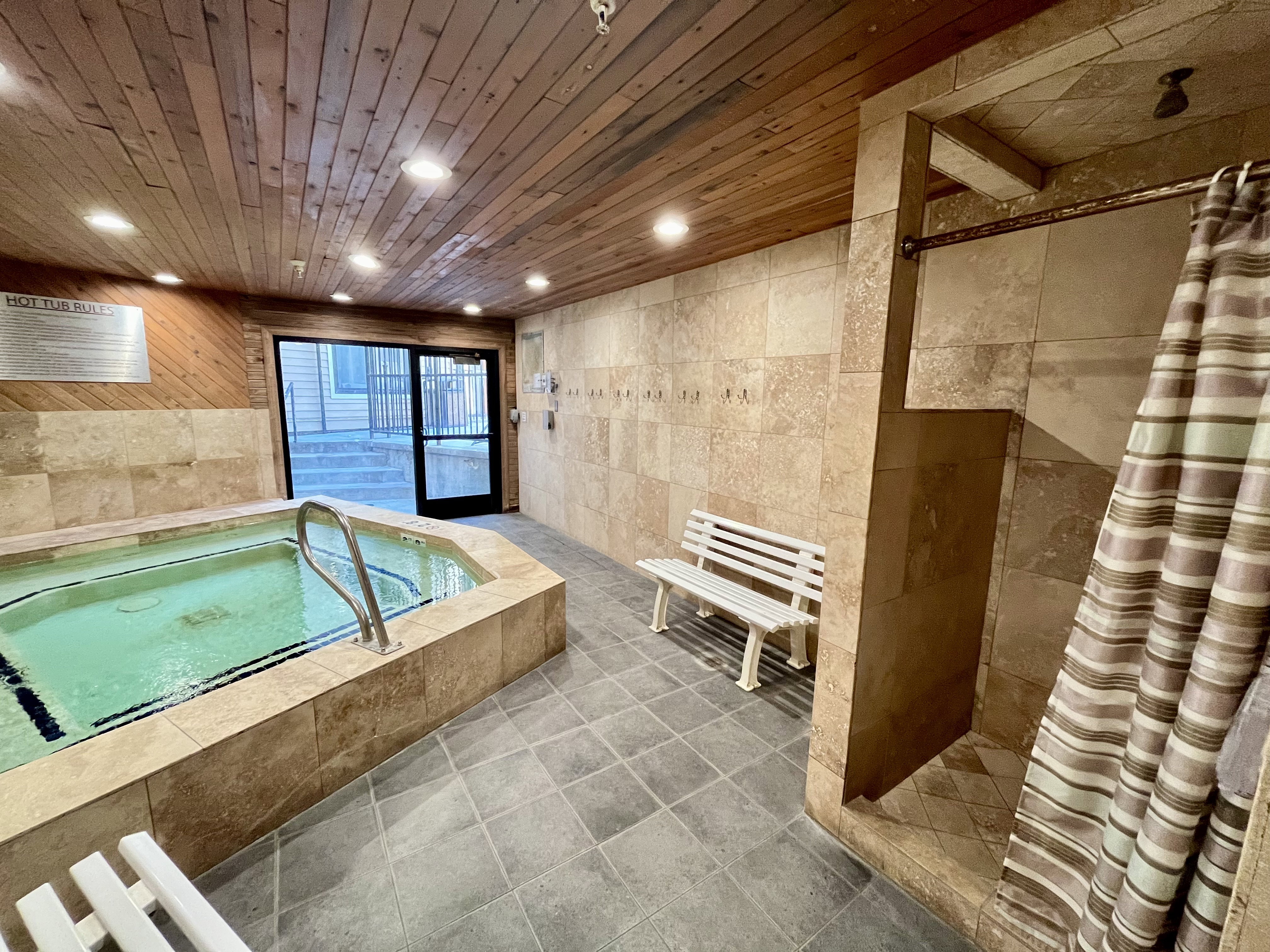 Bathroom with tile walls, a stall shower, a bath, recessed lighting, and tile patterned floors