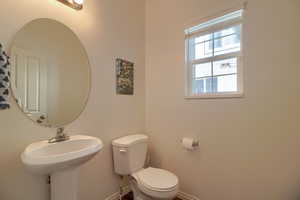 1/2 Bathroom featuring toilet and pedestal sink