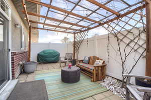 Wooden terrace featuring a patio area, a fenced backyard, and area for grilling
