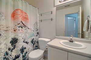 Full bath with vanity and a shower / bath combo with shower curtain