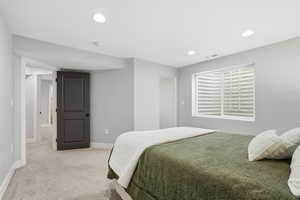 Bedroom featuring light carpet and recessed lighting