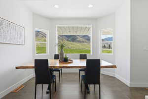 Dining space with hardwood flooring and recessed lighting
