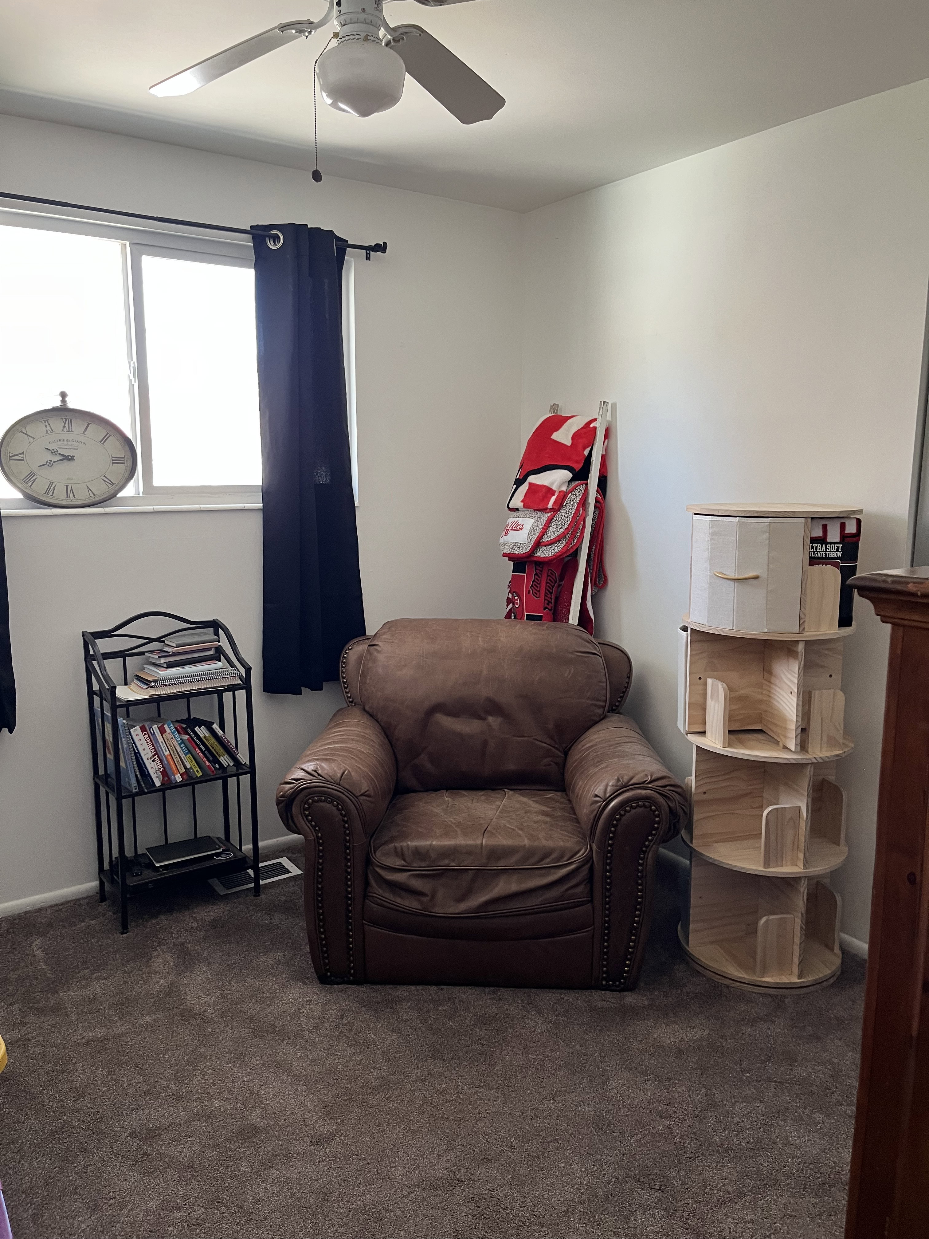 Bedroom/office room with dark colored carpet and ceiling fan