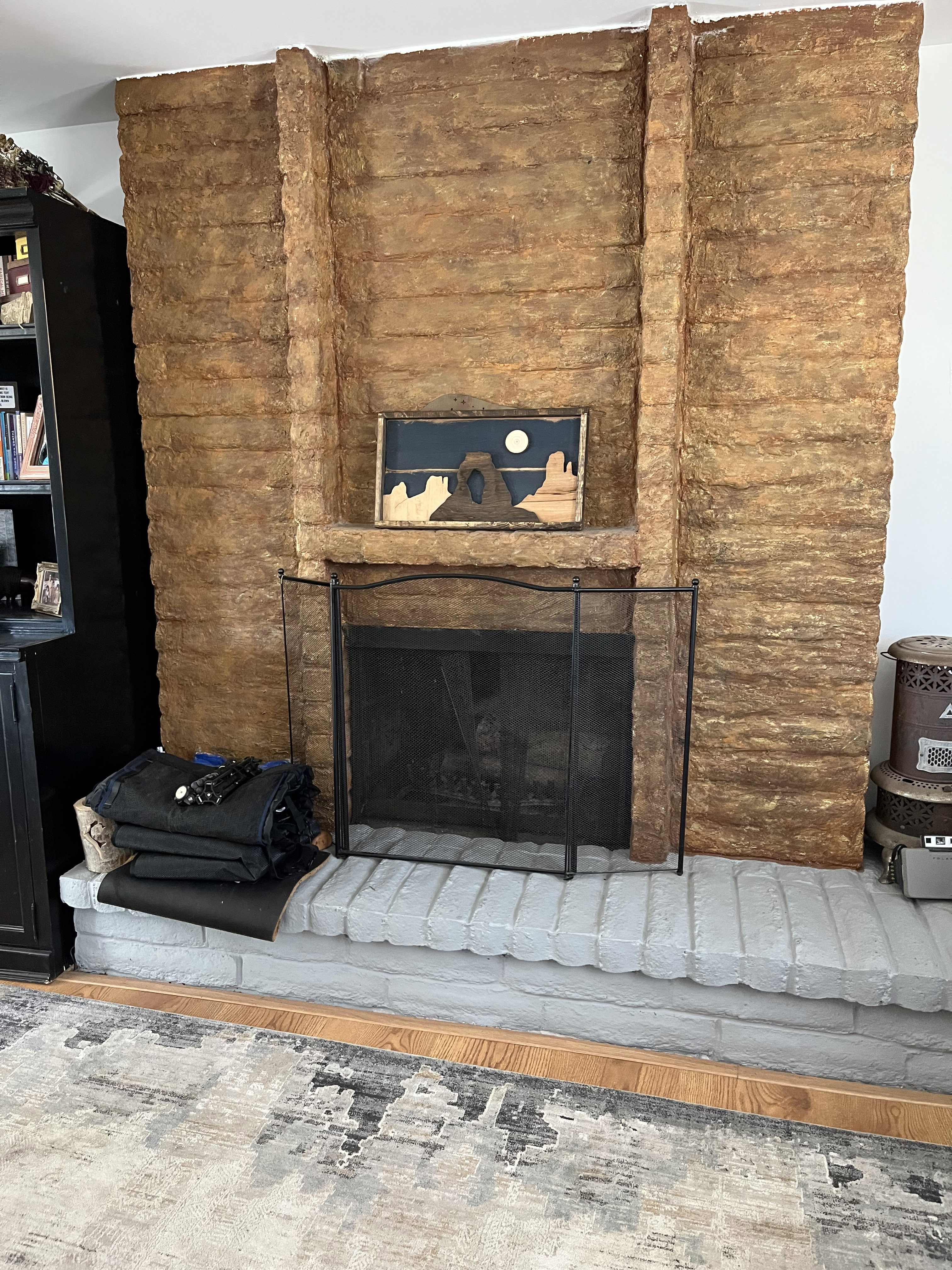 Detailed view of a brick fireplace and wood finished floors