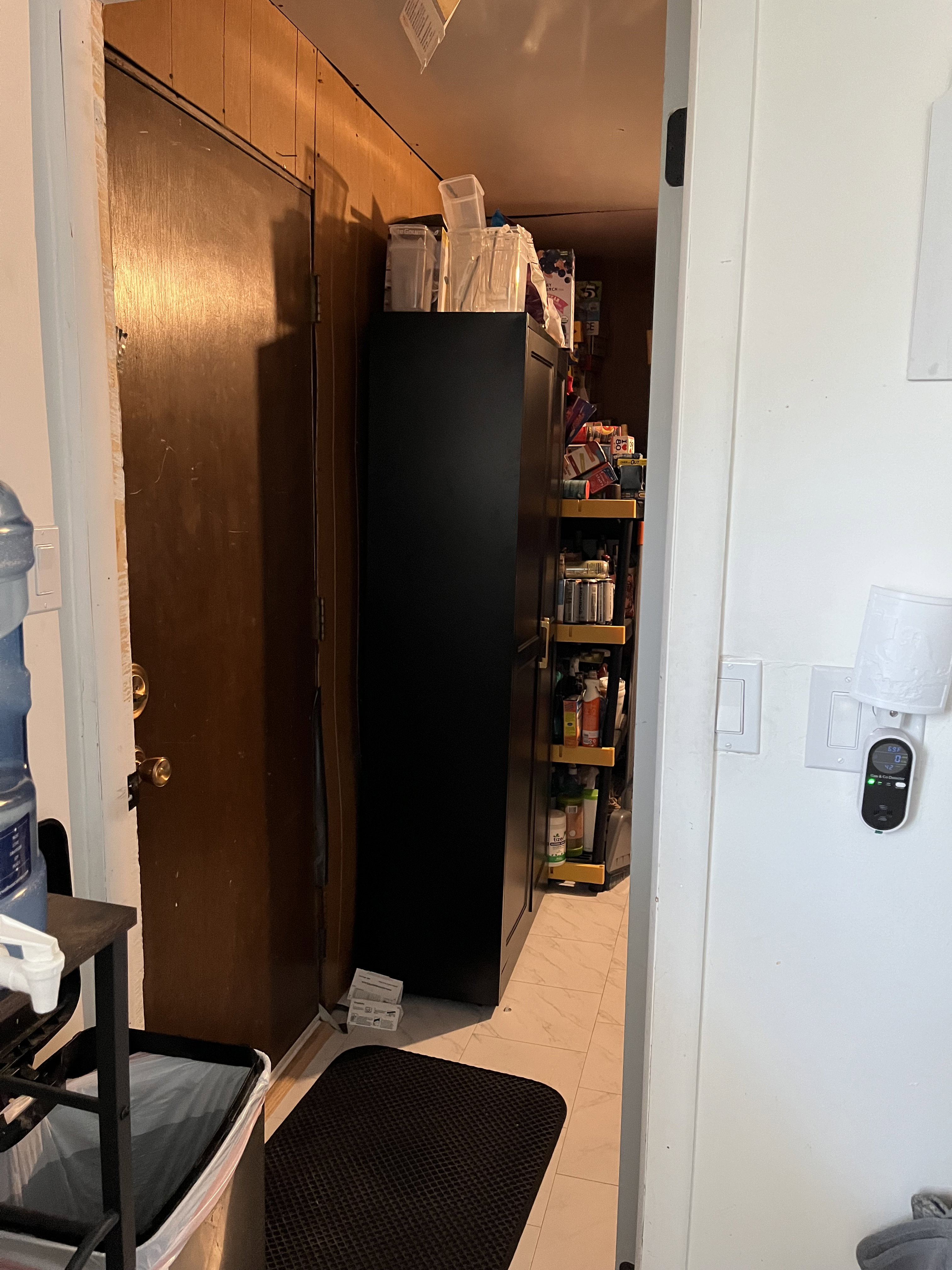View of pantry and door to outside
