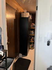 View of pantry and door to outside
