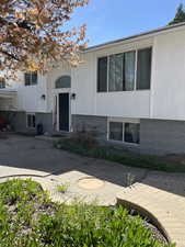 Split foyer home with brick siding and a patio area