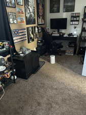 Large office/bedroom area featuring dark carpet