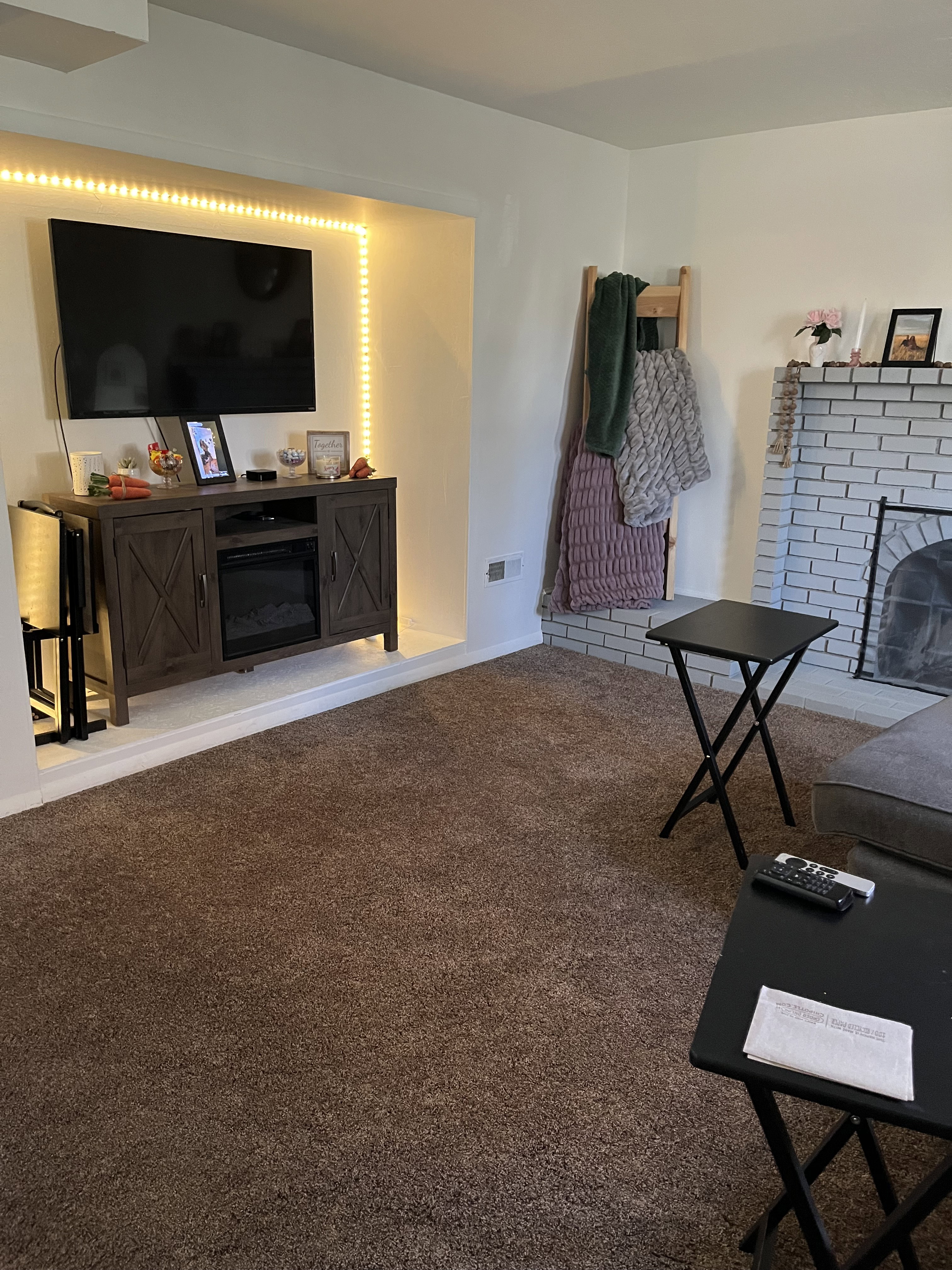 Living room featuring a brick fireplace and carpet flooring