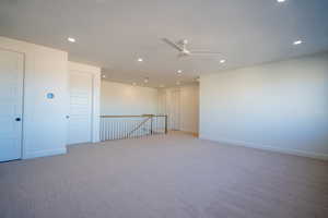 Spare room with ceiling fan, recessed lighting, and carpet flooring