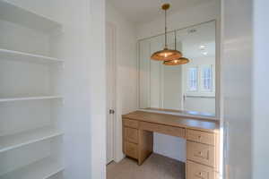 Unfurnished office featuring built in study area, light carpet, and recessed lighting