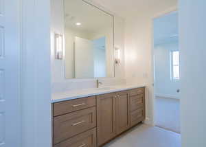 Bathroom featuring vanity and light colored carpet
