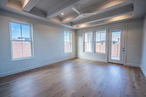 Spare room featuring a ceiling fan, dark wood-style flooring, ornamental molding, beam ceiling, and recessed lighting