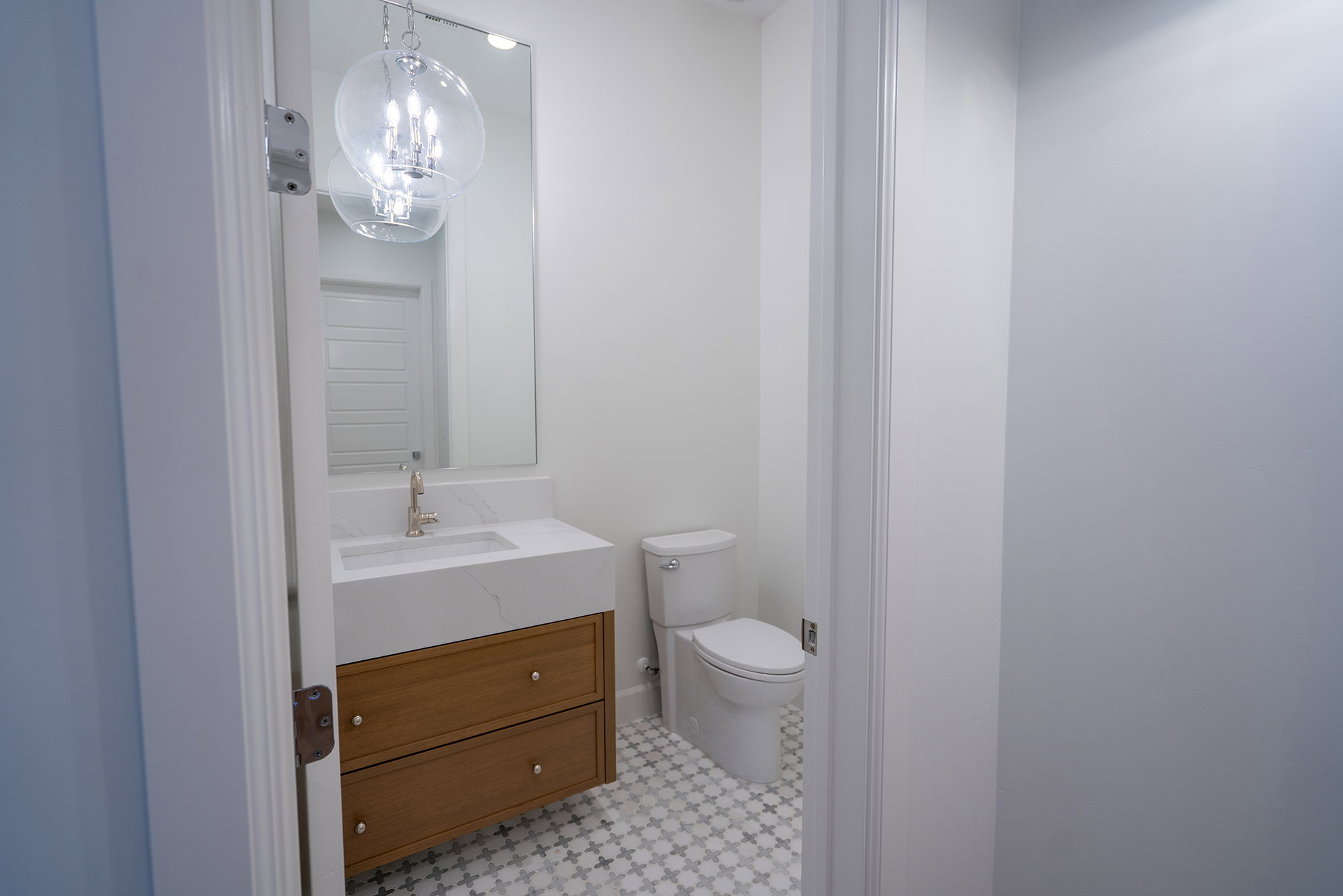 Bathroom featuring vanity and a chandelier