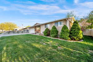 View of front of property with a patio, a garage, and driveway