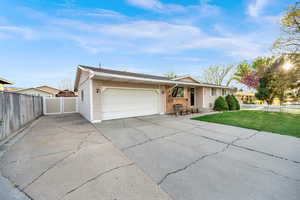 Ranch-style house with concrete driveway, an attached garage, and brick siding