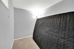 Unfurnished room featuring light colored carpet and baseboards