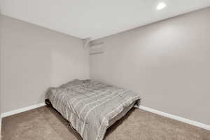 Bedroom with light colored carpet