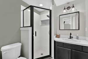Bathroom featuring vanity and a shower stall