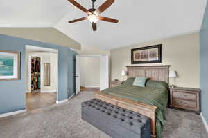 Bedroom featuring a ceiling fan, a spacious closet, and light colored carpet