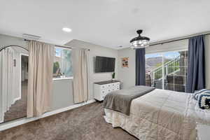 Bedroom with dark colored carpet, access to outside, and recessed lighting