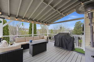 Wooden terrace with area for grilling and outdoor furniture