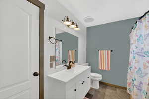 Bathroom with vanity and curtained shower