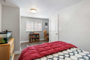 Carpeted bedroom featuring baseboards