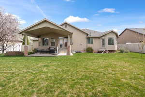 Back of house with entry steps, a patio area, and stucco siding