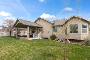 Rear view of property with a patio area, roof with shingles, and stucco siding