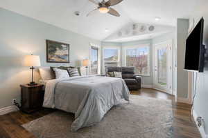 Bedroom featuring access to outside, dark wood-style flooring, and ceiling fan