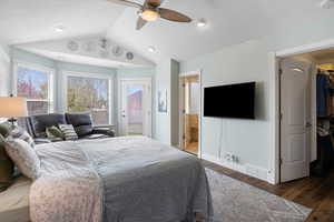 Bedroom with wood finished floors, ceiling fan, access to exterior, and a spacious closet