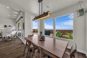 Dining area featuring dark wood finished floors and baseboards