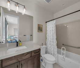 Full bath with vanity, shower / tub combo with curtain, and ensuite bathroom