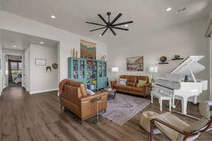 Living area with wood finished floors, a ceiling fan, and recessed lighting