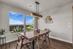 Dining room featuring dark wood-style floors and a mountain view