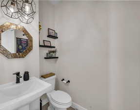 Half bathroom with toilet and a sink