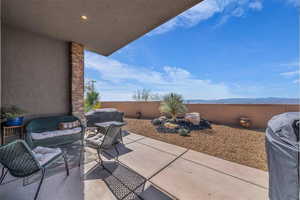 Fenced backyard featuring a patio and a mountain view