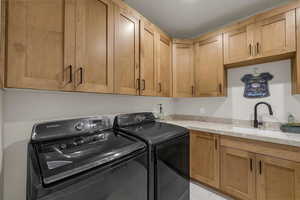 Laundry area with washing machine and dryer and cabinet space