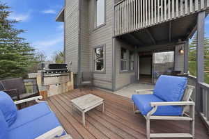 Wooden terrace featuring area for grilling