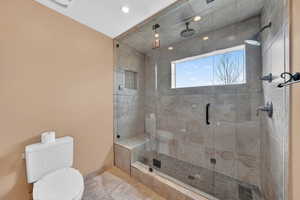 Bathroom featuring toilet and a shower stall