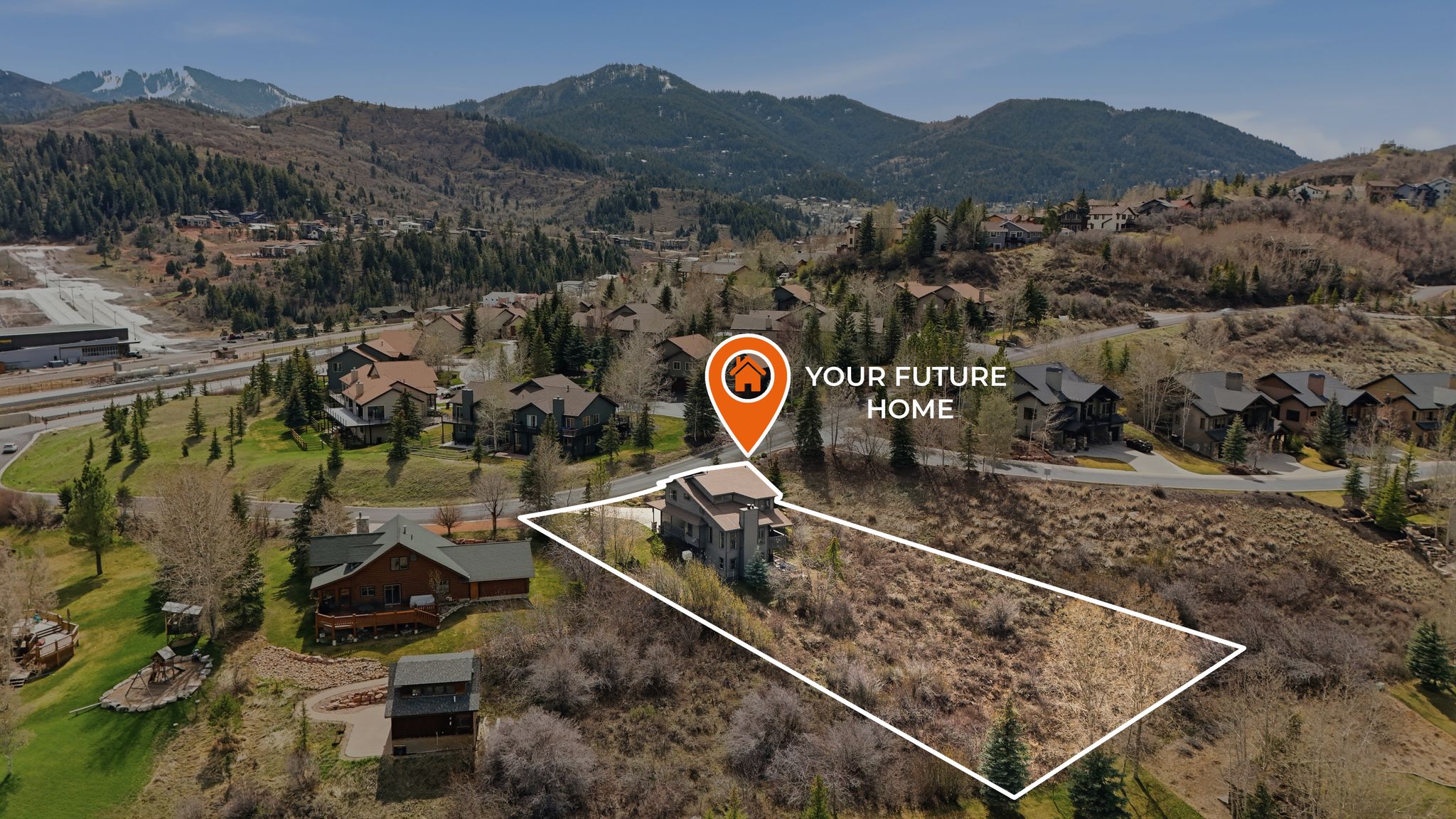 Aerial view of residential area featuring property boundaries highlighted and a mountainous background