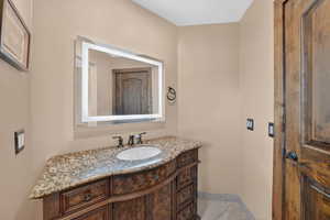 Bathroom featuring vanity and baseboards